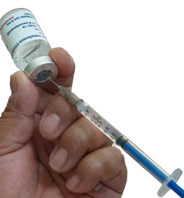 A hand drawing vaccine from a vial into a syringe