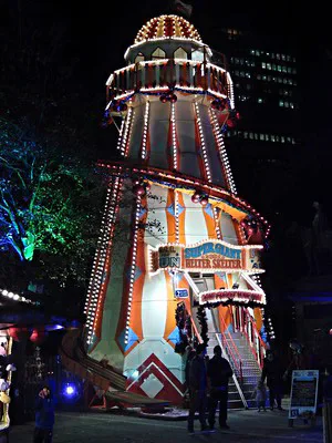 An illuminated helter skelter at Winter Wonderland at night