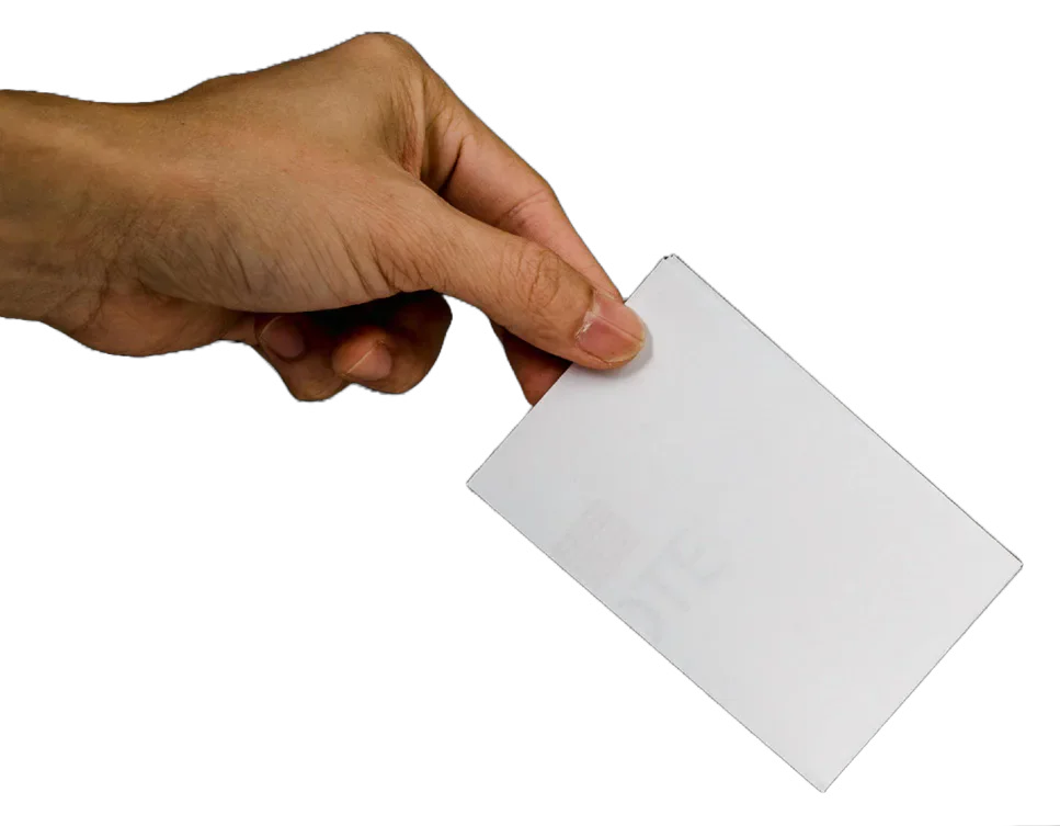 A hand inserting a blank ballot paper