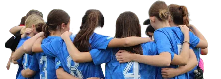 Women footballers in blue shirts standing in a team huddle