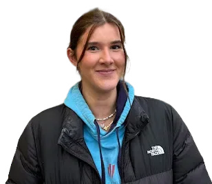 Portrait of Beca Parry wearing a blue hoodie and black jacket