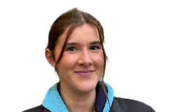 Portrait of Beca Parry wearing a blue hoodie and black jacket