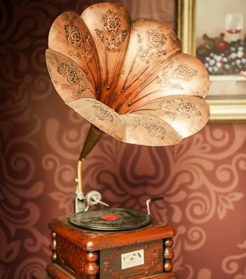 Ornate vintage gramophone with a large brass horn.