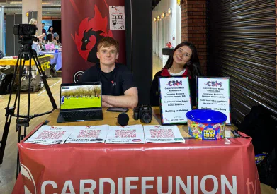 Student media members at a Cardiff Union TV stall.