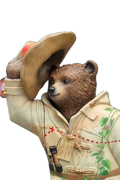 A Paddington Bear statue raising its hat.