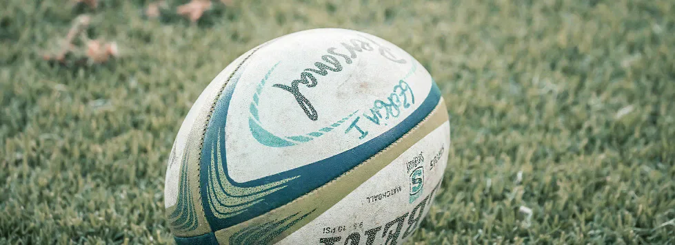A rugby ball lying on grass.