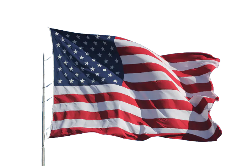 The flag of the United States flying from a pole.
