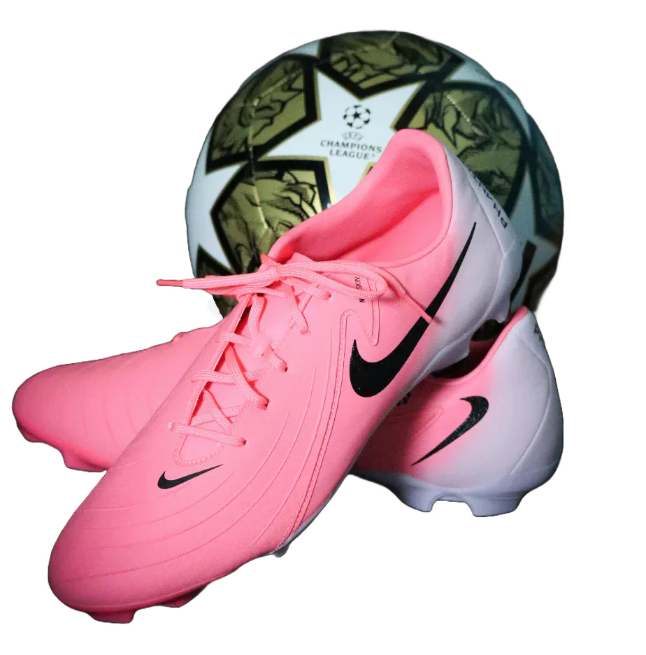 Pink football boots in front of a football.