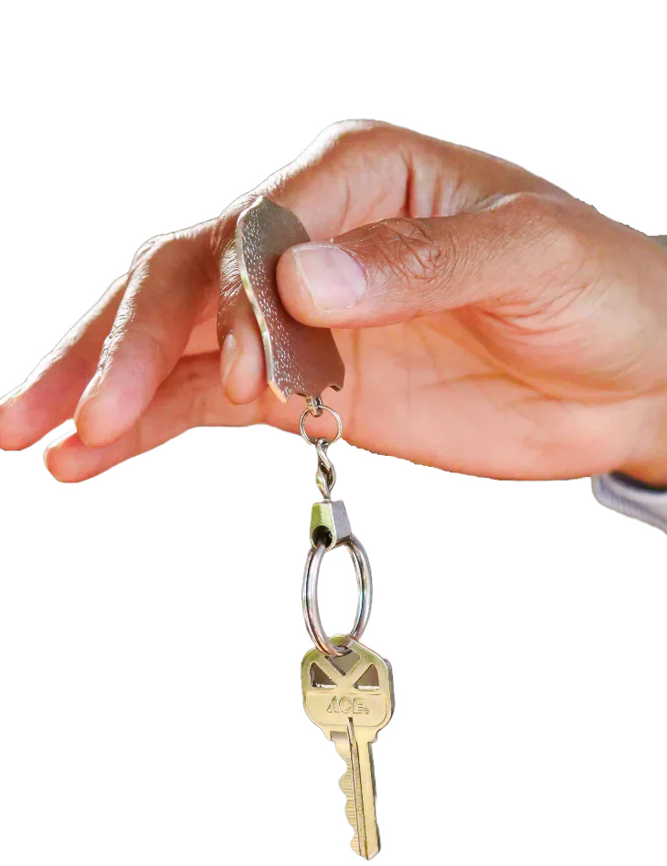 A hand holding a set of house keys