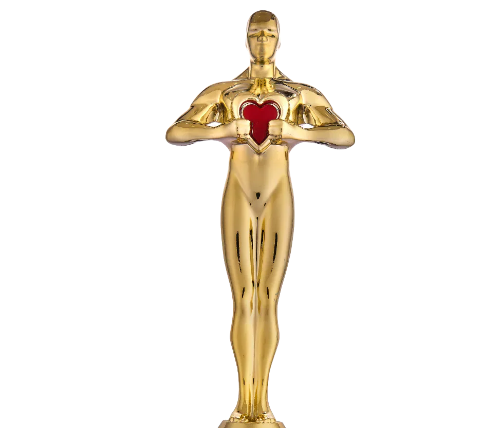 A gold award statuette holding a red heart