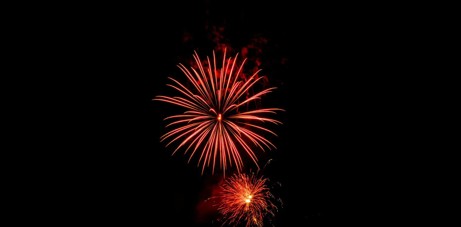 Red fireworks against a dark sky