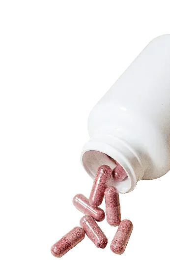 Pink capsules spilling from a white bottle