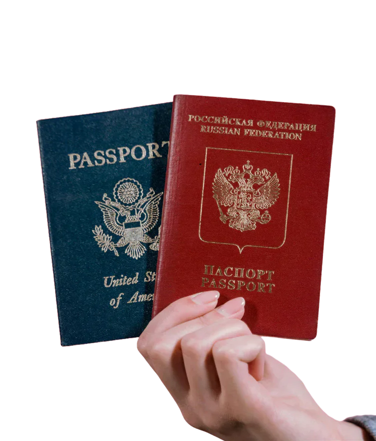 A hand holding US and Russian passports