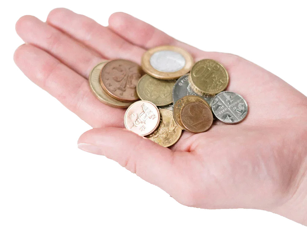 A hand holding British coins