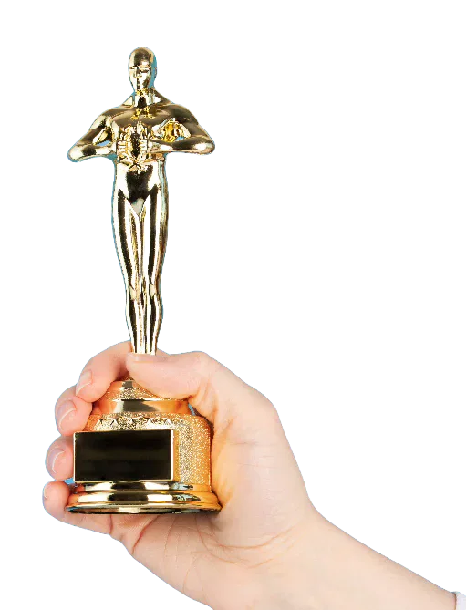 A hand holding an Oscar statuette