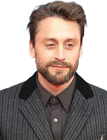 Kieran Culkin wearing a dark pinstriped jacket