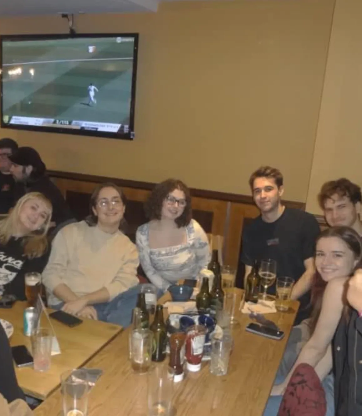 A group seated around a table with drinks.
