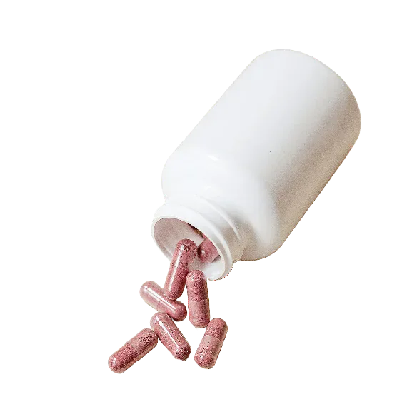 Pink capsules falling from an open white medicine bottle