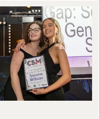 Two attendees holding a Cardiff Student Media award