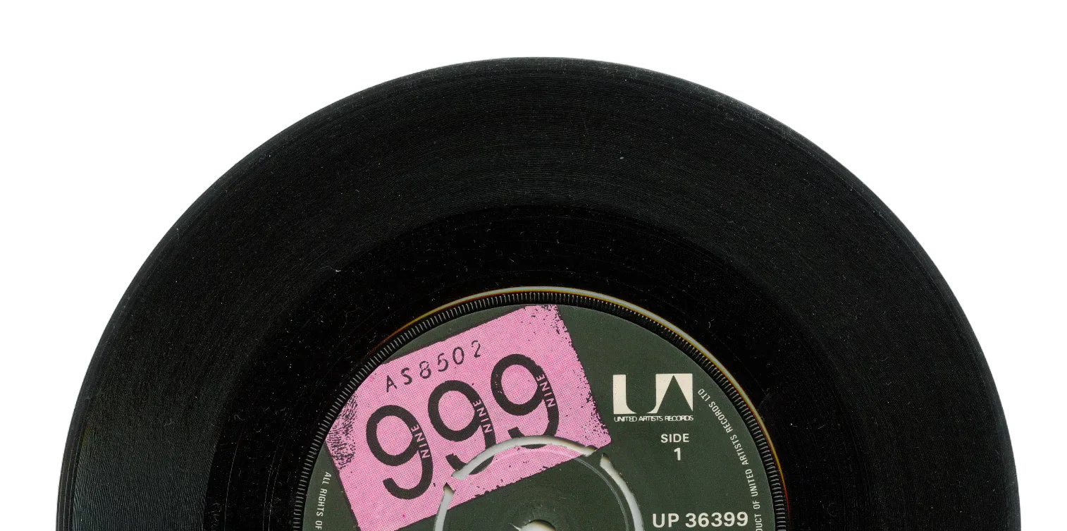 Black vinyl record with a pink and green label