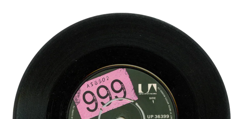 Black vinyl record with a pink and green label