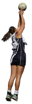 A Cardiff University netball player reaching up with the ball.