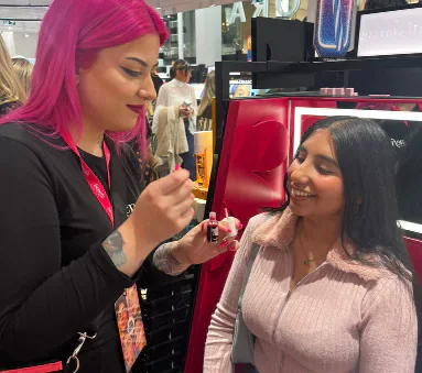 A Sephora employee applying makeup to a guest at the Cardiff launch.