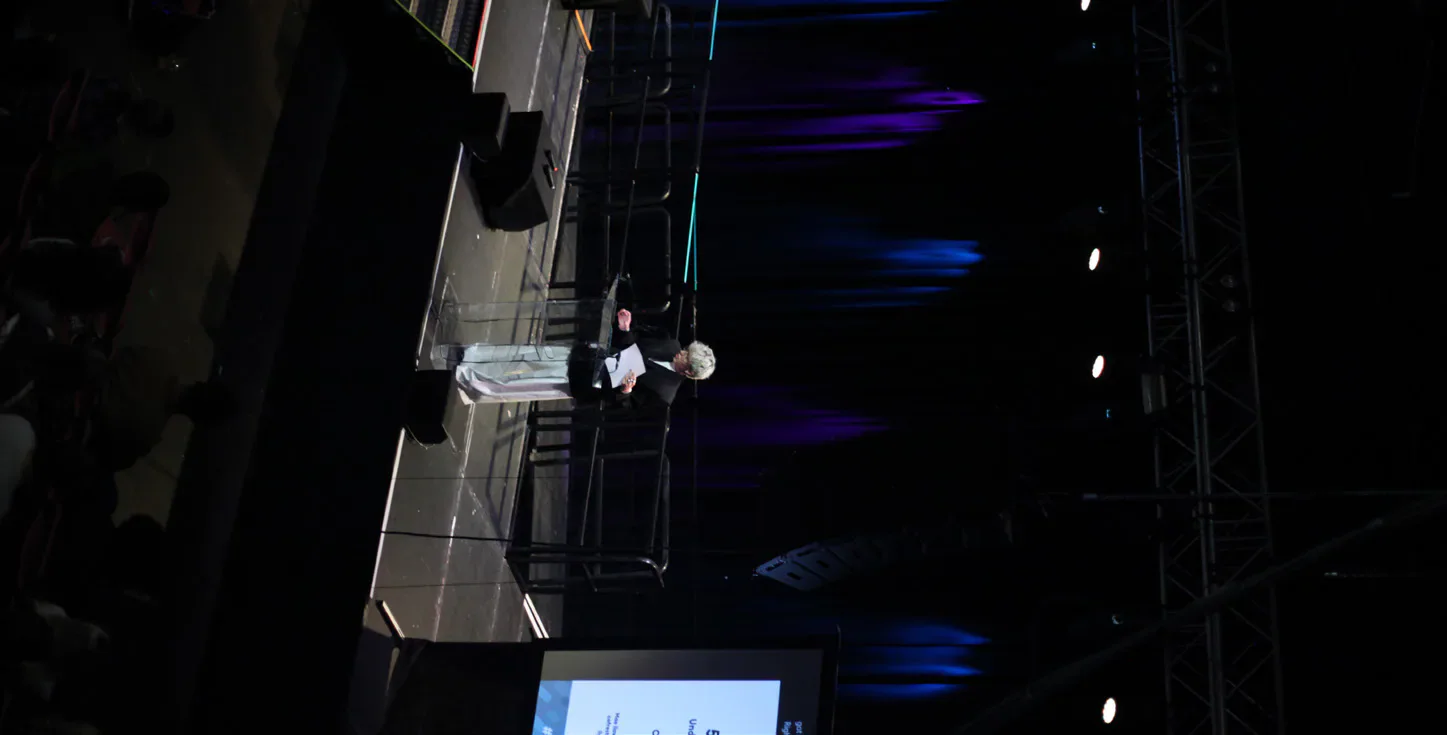 A speaker addresses the Cardiff Students’ Union AGM from the Great Hall stage