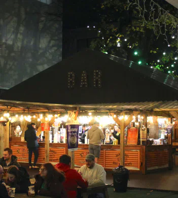 Visitors at a Christmas market food stall