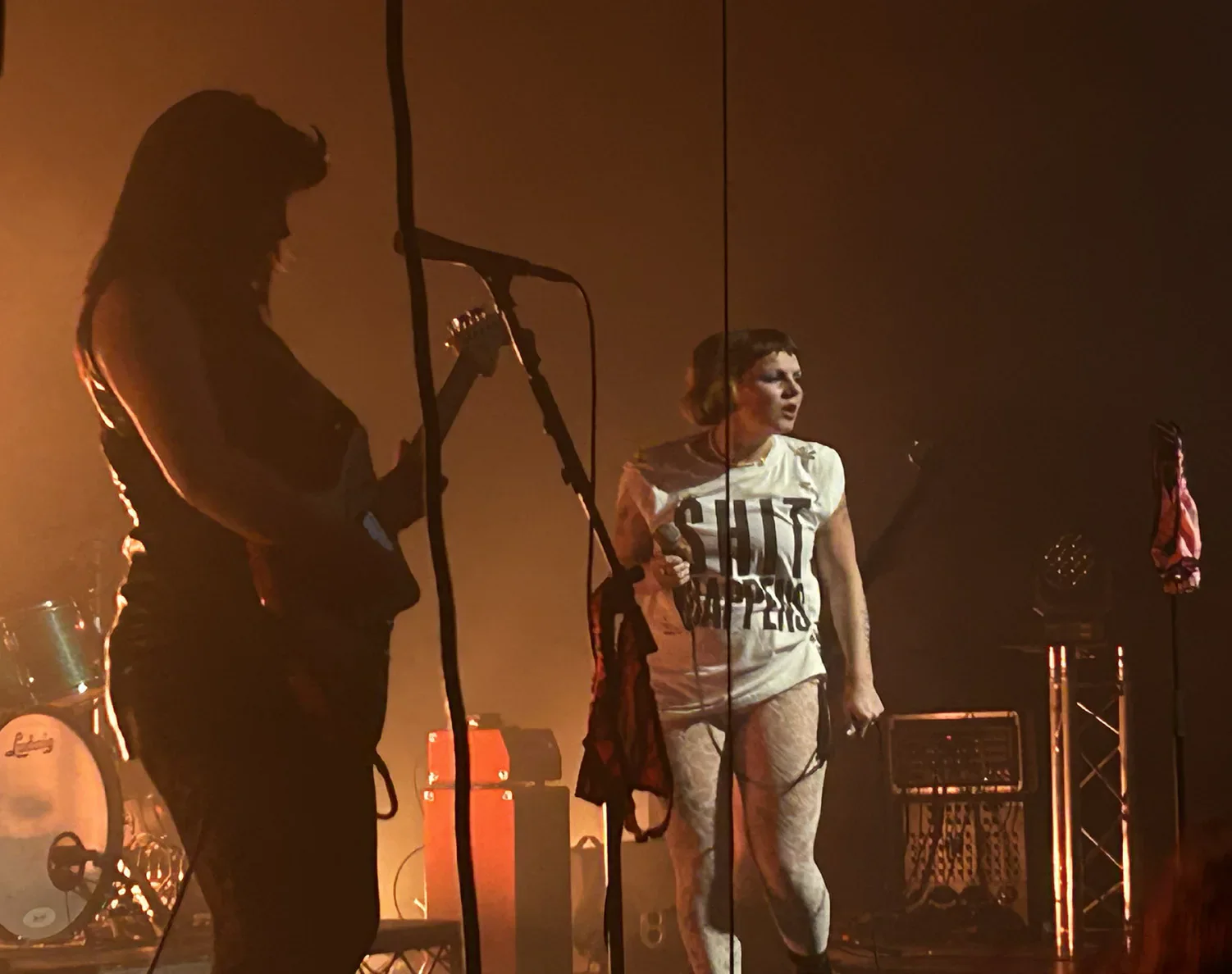 Panic Shack performing under orange stage lights.