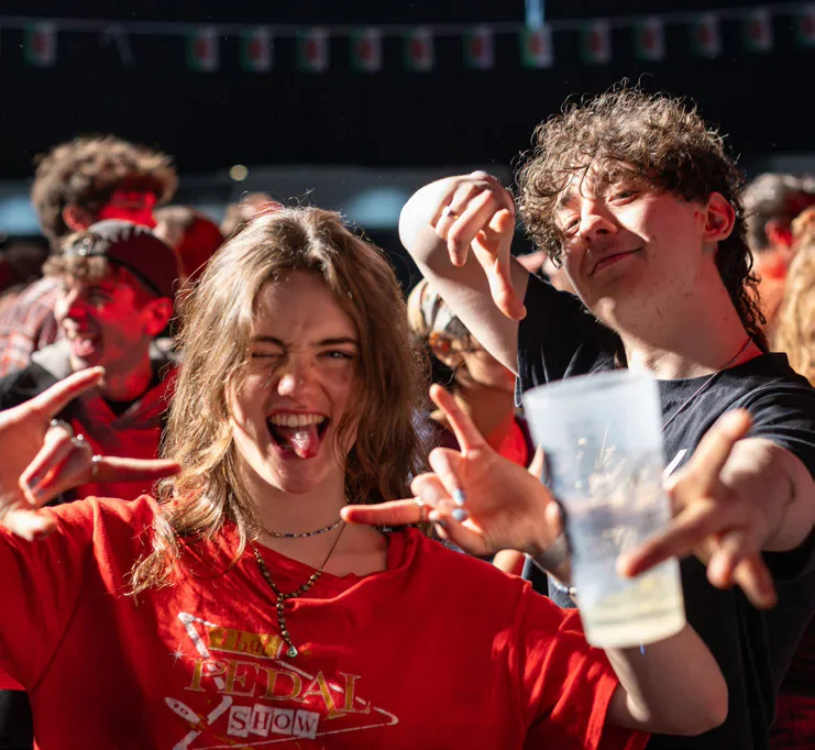 Students celebrating with drinks at the festival.