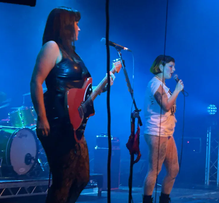 Panic Shack performing under blue stage lights.