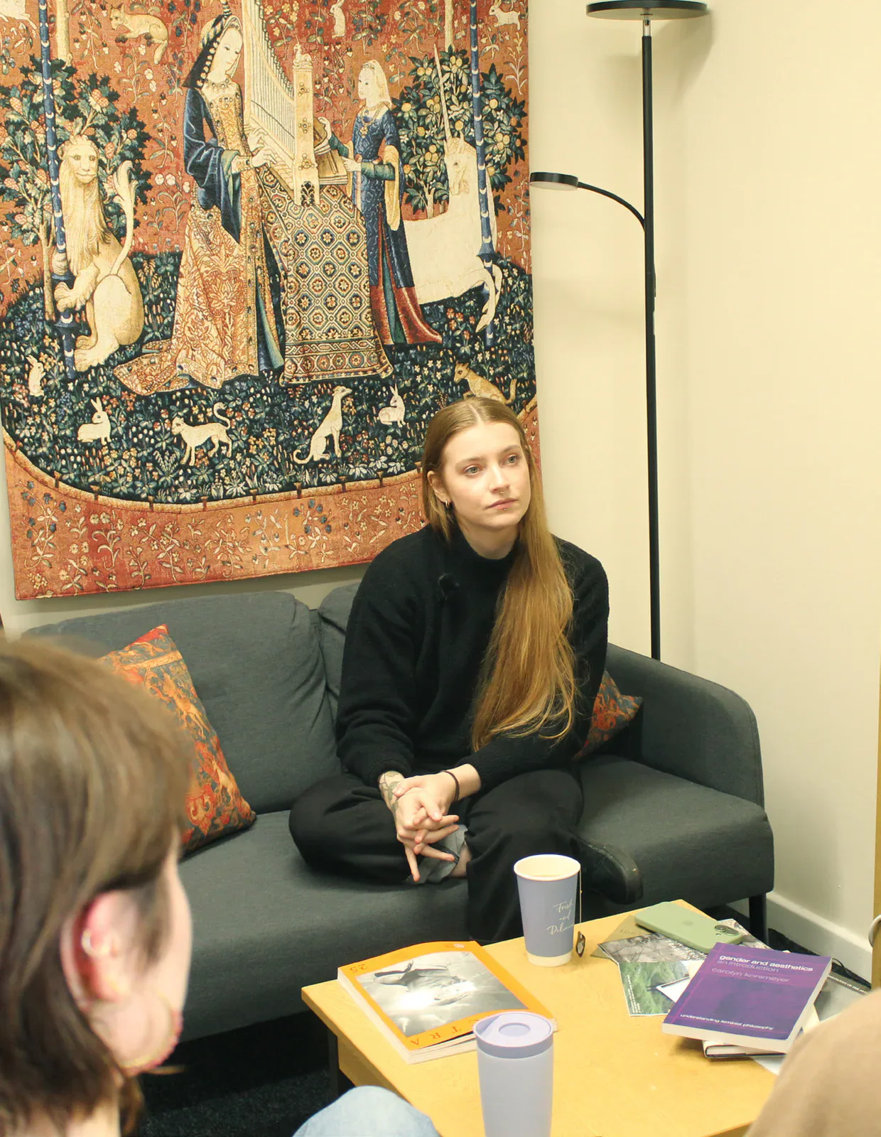 Philosopher Daisy Dixon seated during the Gair Rhydd interview.