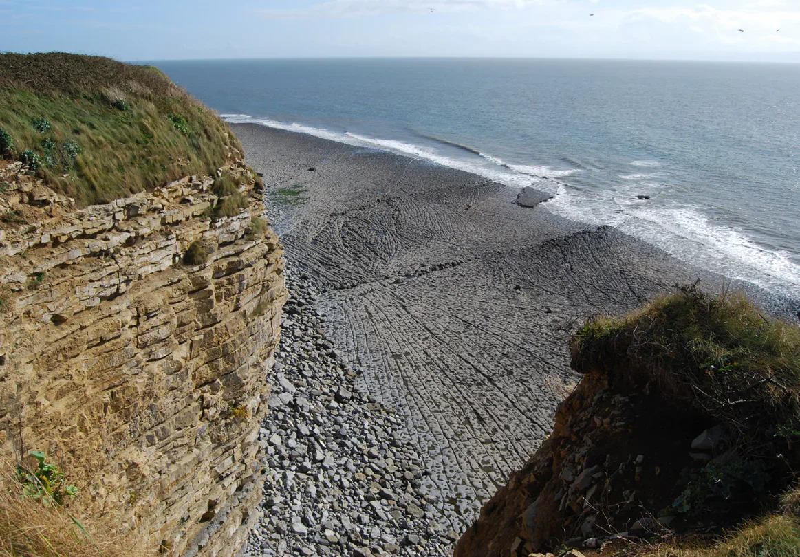 Eroding layered cliffs and rocky shore on the Vale of Glamorgan coast.