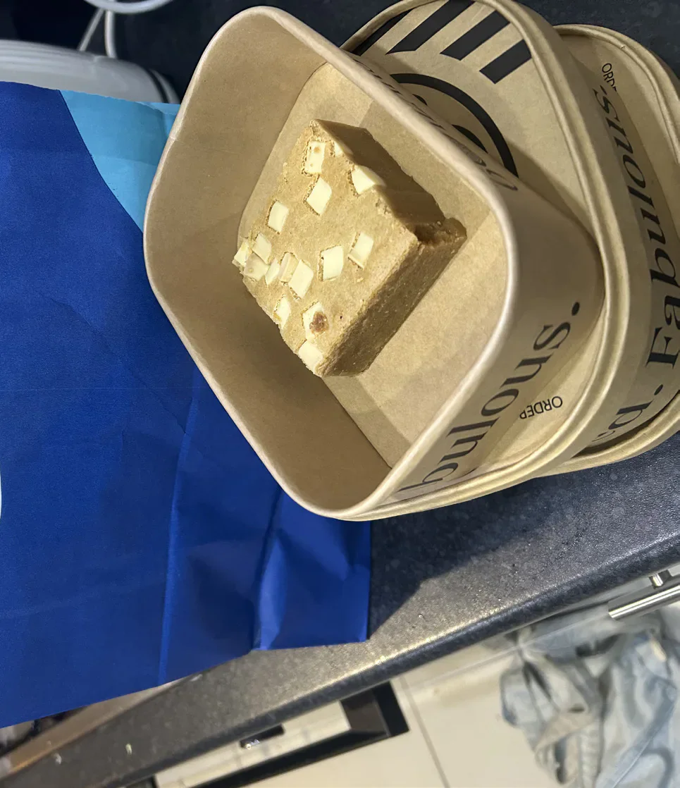 White-chocolate blondie in a takeaway box.