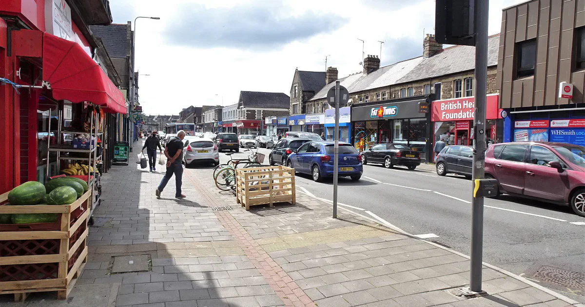 View along Albany Road in Roath, with shops, pedestrians and traffic