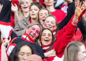 Cardiff supporters in red cheer from the stands.