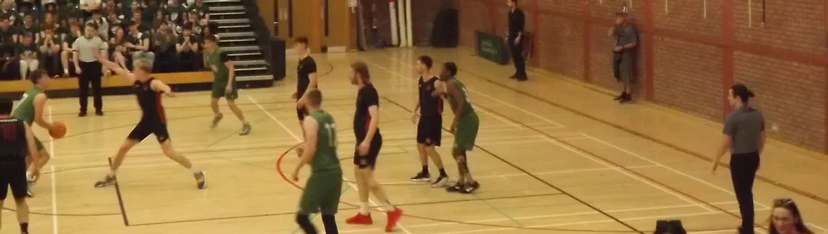 Cardiff and Swansea players contest possession on the basketball court.