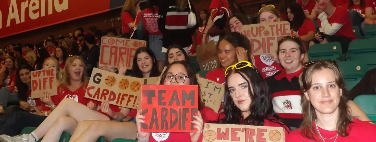 Cardiff supporters hold handmade signs in the stands.