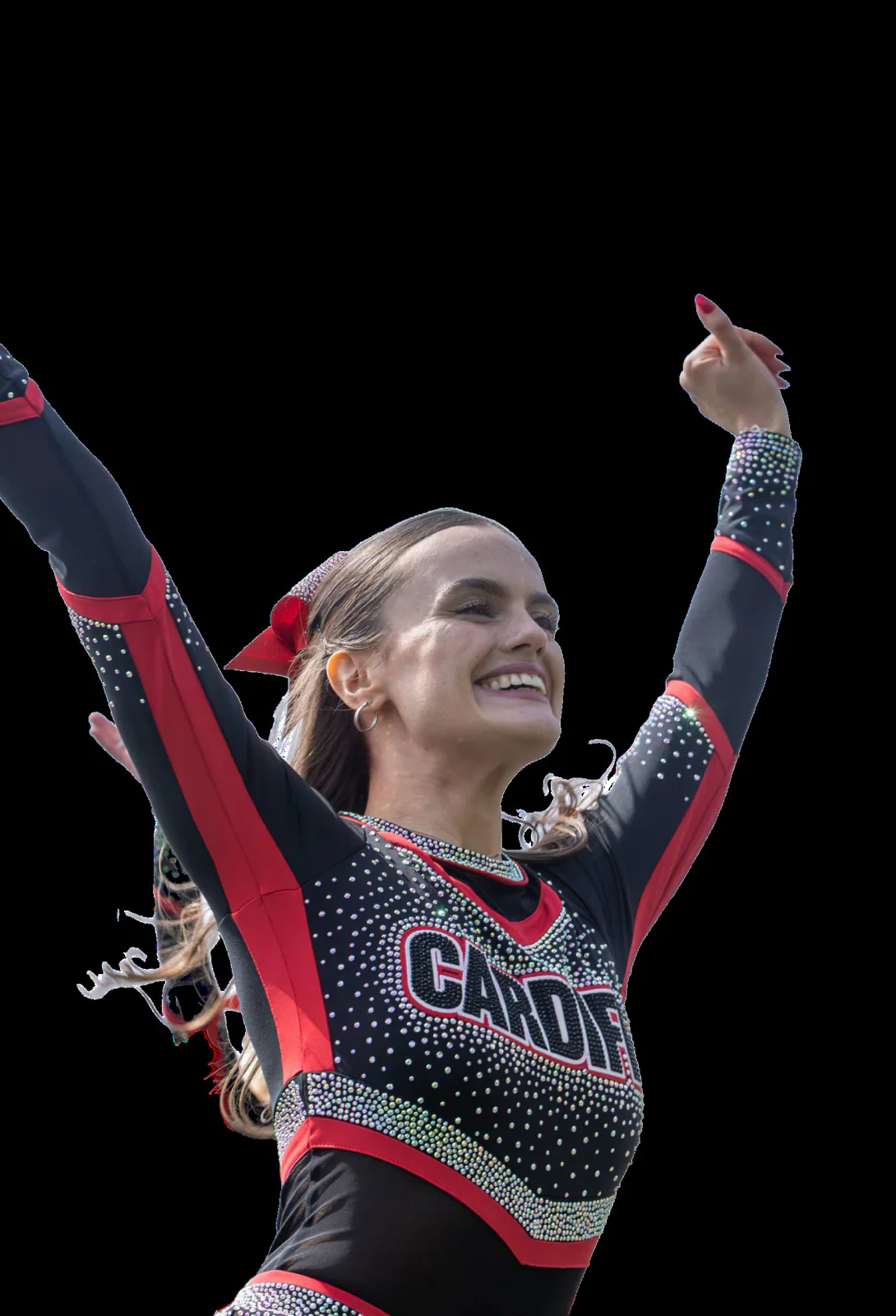 A Cardiff cheerleader performs with both arms raised.