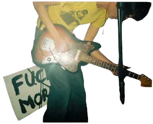 A MORN guitarist playing beside a handmade sign.