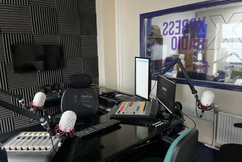Microphones, mixing desks and computer screens in the Xpress Radio studio.