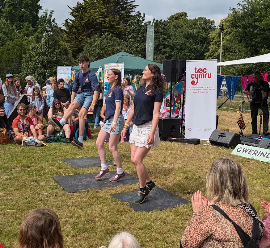 Performers dancing on an outdoor stage at Tafwyl.