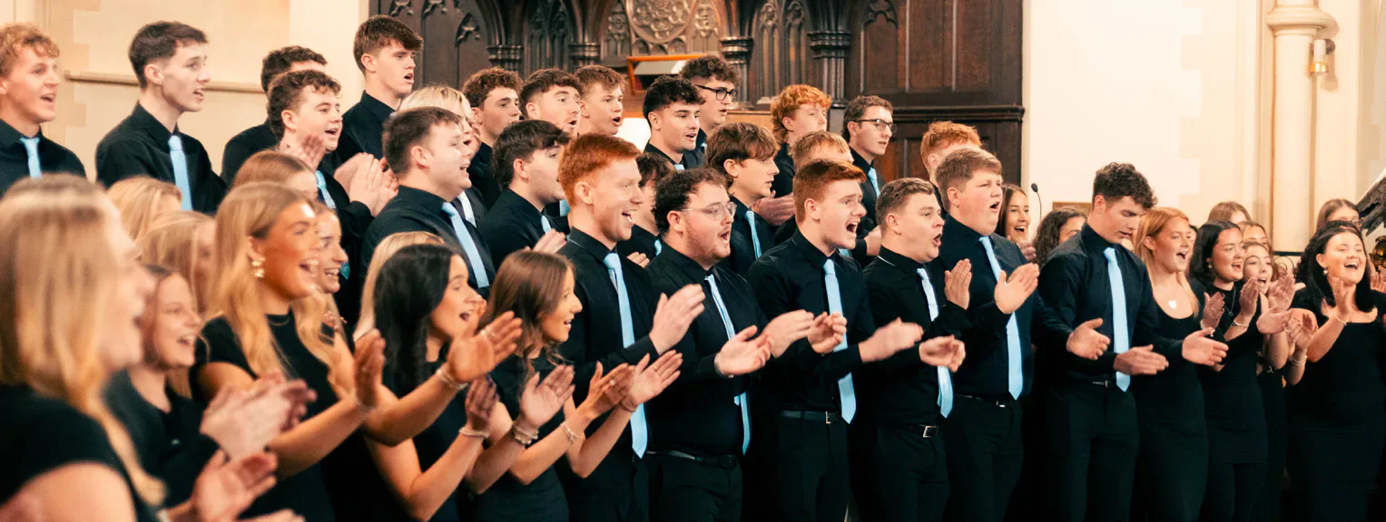 A student choir performing indoors.