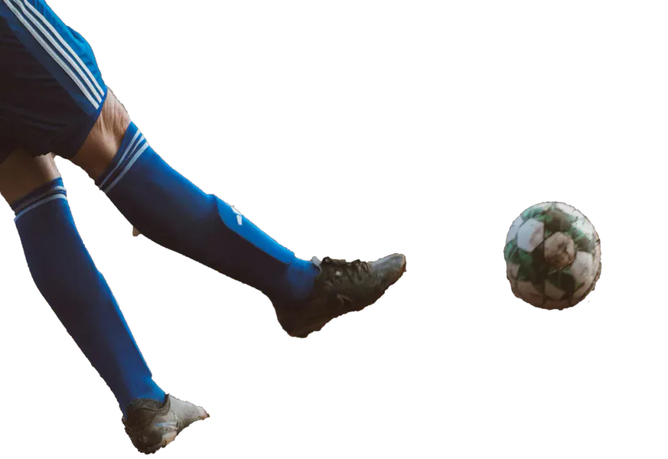 Footballer’s legs beside a football.