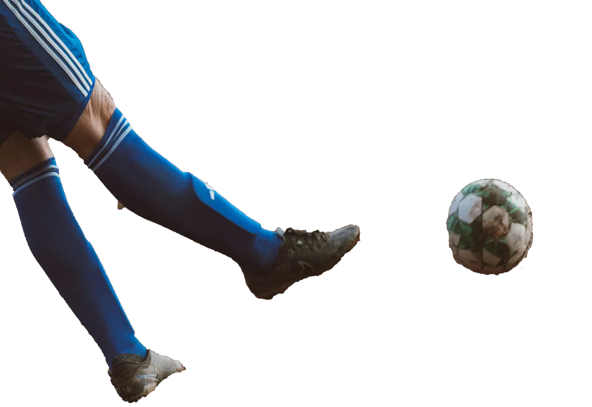 Footballer’s legs beside a football.