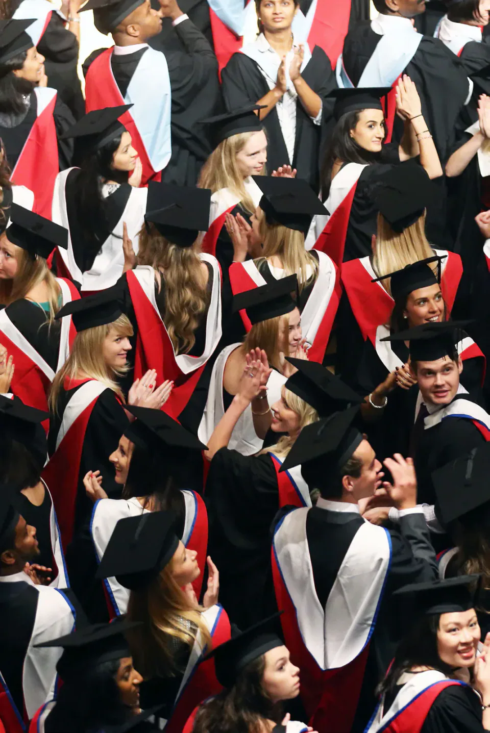 Graduates in gowns gathered at a Cardiff University graduation ceremony.