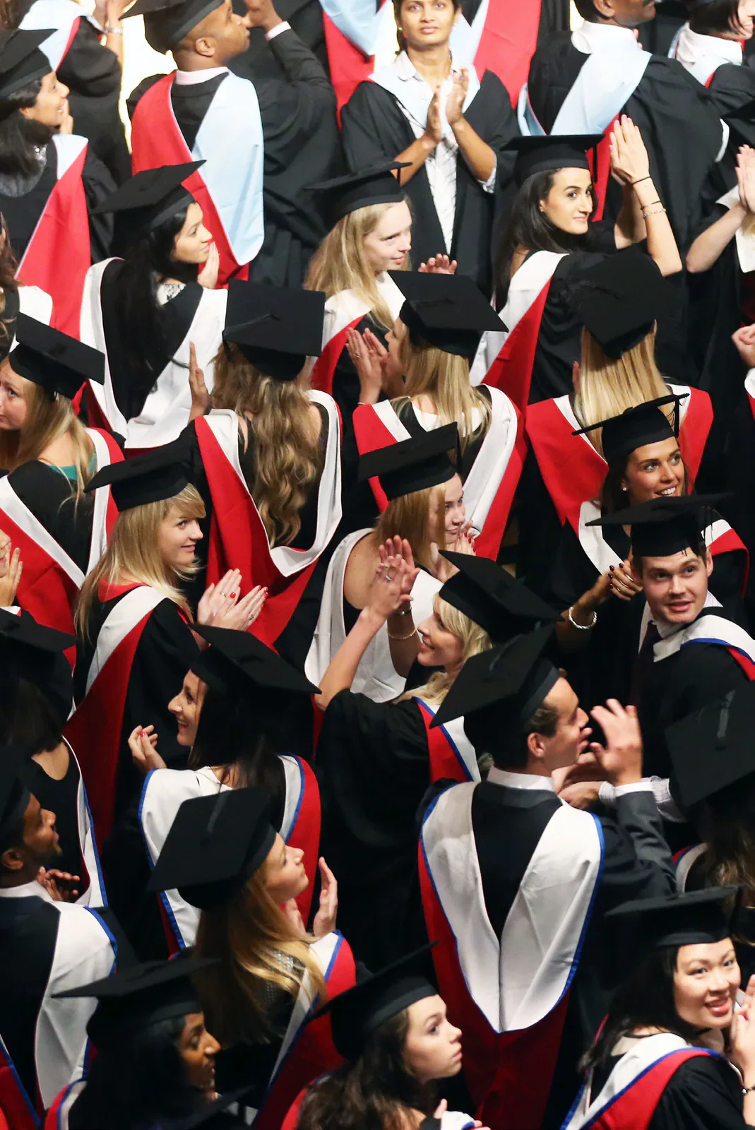 Graduates in gowns gathered at a Cardiff University graduation ceremony.