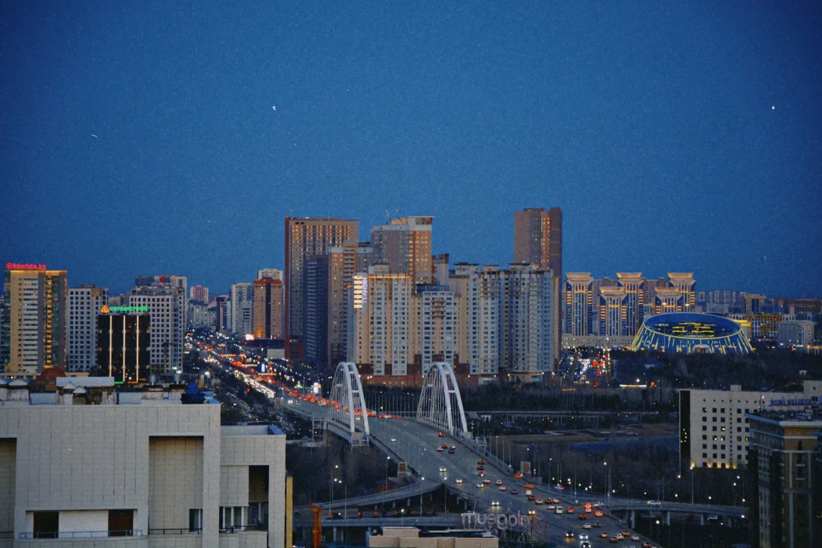 Astana Skyline at Night with an Illuminated Bridge