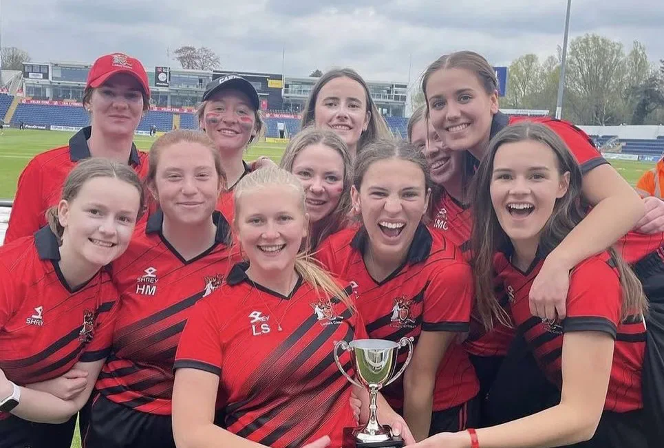 Cardiff women pose with the cricket trophy after their Varsity victory.